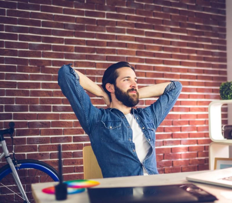 thoughtful-businessman-with-hands-behind-back-relaxing-in-creative-office-1-phufh3gaxm1lplis4xsifalghuh7zieupsknpui060